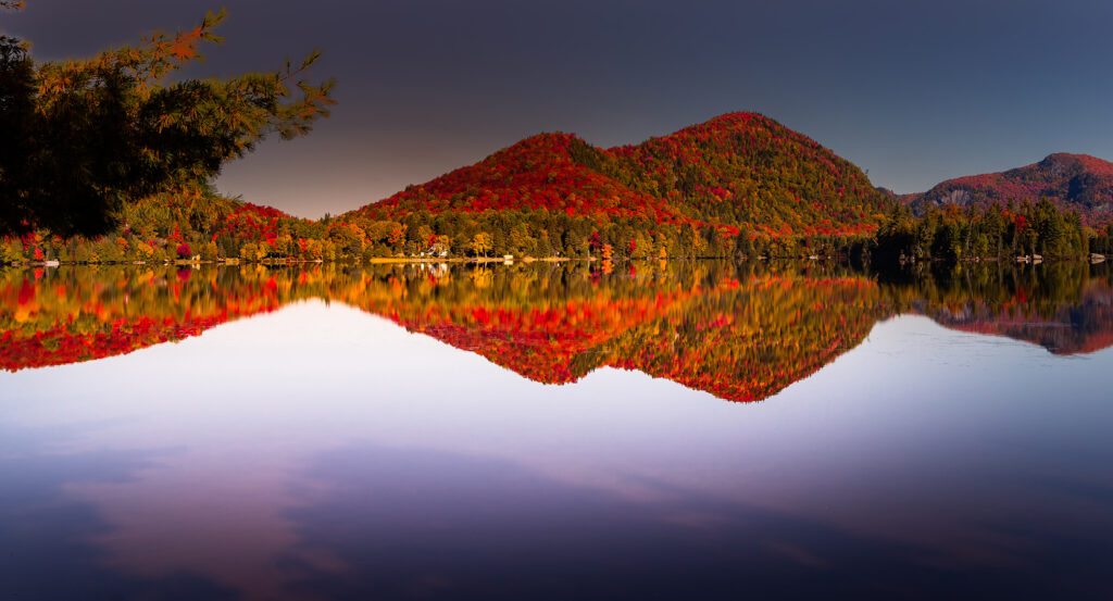 Mountain and forest mirrored in Lac Supérieur at sunset