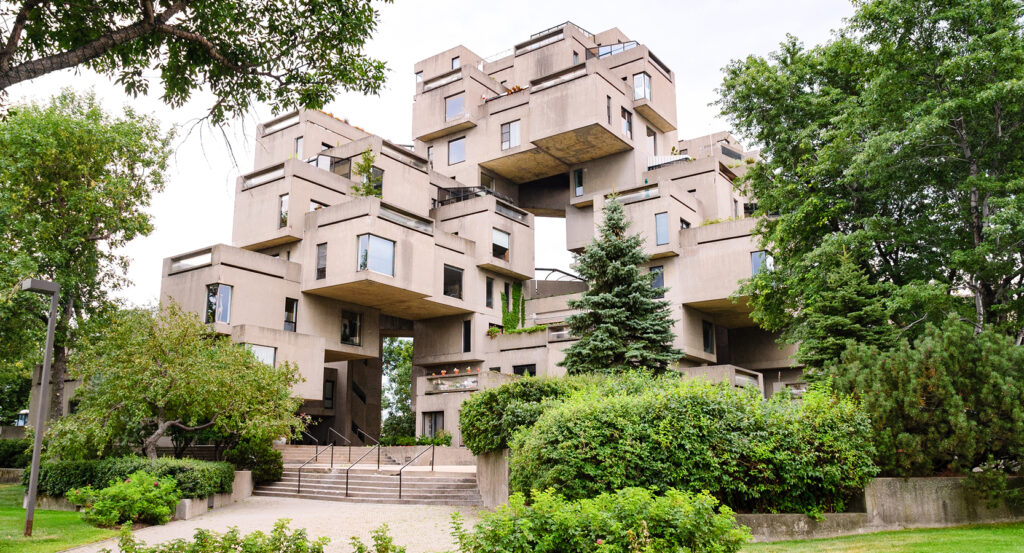 View of Habitat 67 housing complex in Montreal surrounded by greenery