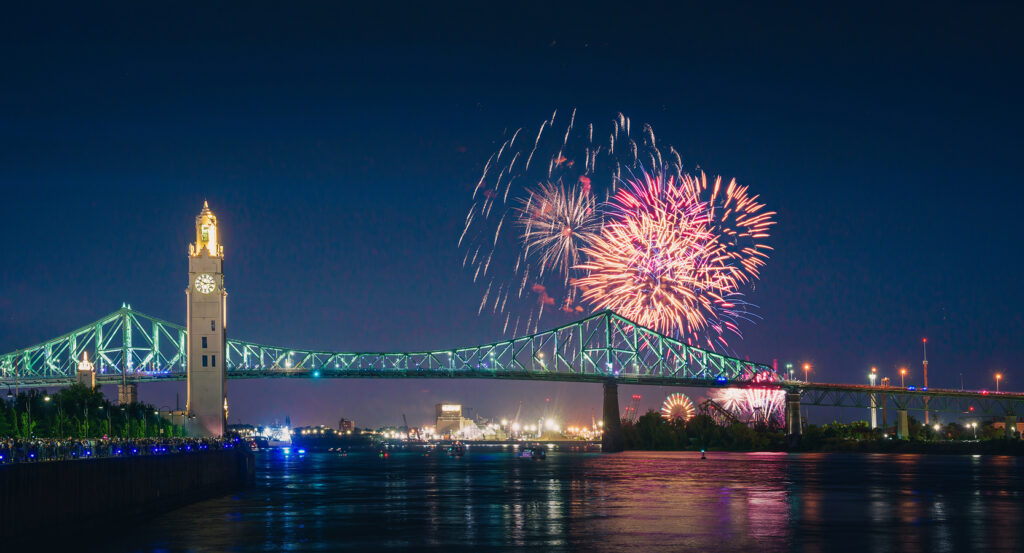 Scenic view of Old Port of Montreal lit up at night with river reflections