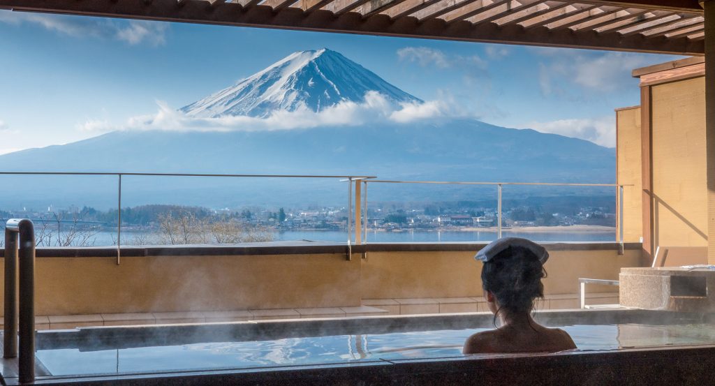 Japanese hot spring bath overlooking Mount Fuji on a winter morning