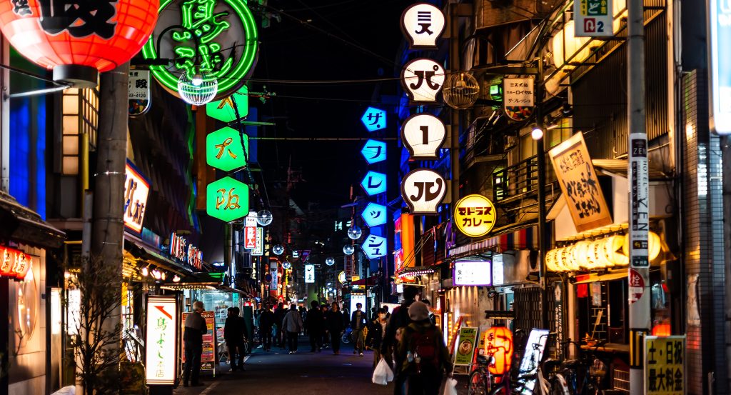 Neon-lit alleyway in Osaka’s Ura-Namba district with hidden snack bars