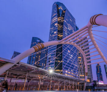 Modern skyscrapers and iconic skywalk at Chong Nonsi in Bangkok at dusk