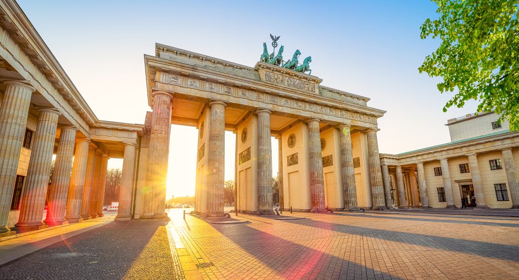 Iconic Berlin landmark bathed in golden morning light.