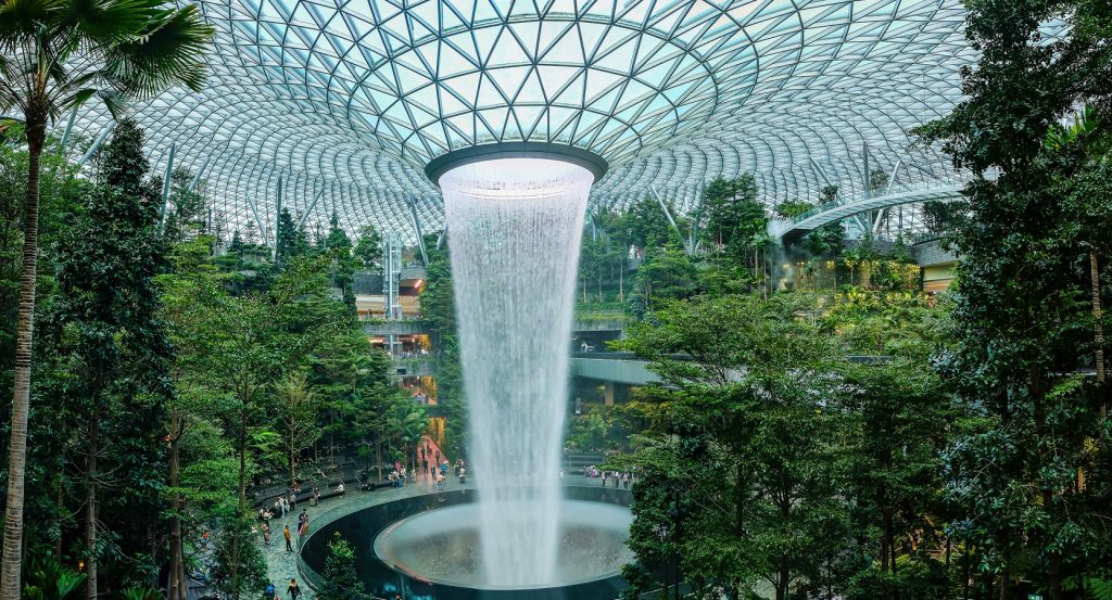 Lush indoor rainforest under a glass dome at Singapore’s Jewel complex.