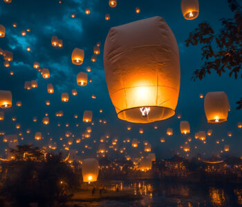 Floating lanterns illuminating Chiang Mai night sky during lantern festival