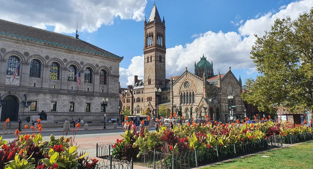 Historic architecture in downtown Boston with vibrant landscaping and pedestrians walking through the heart of the city’s literary and religious legacy.