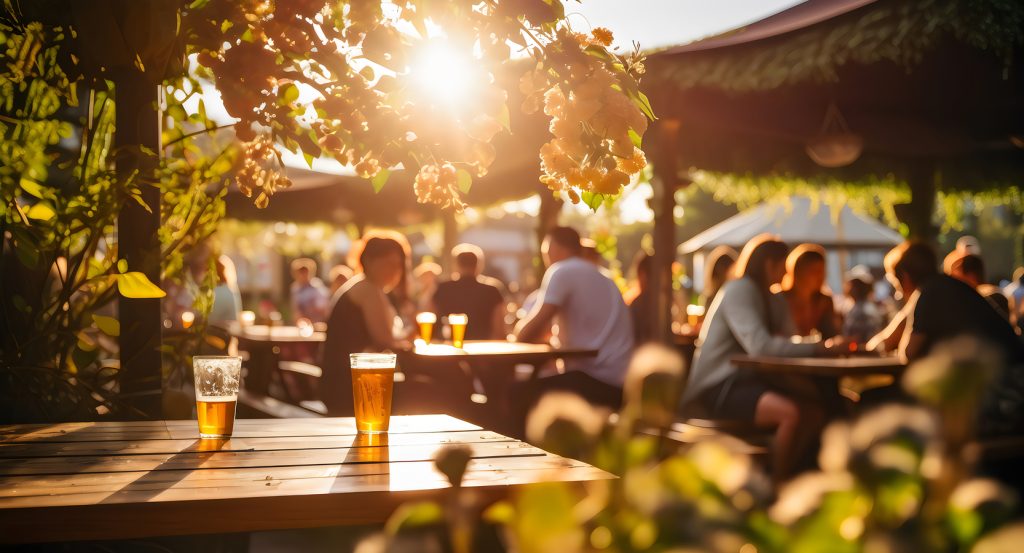 Craft beer pints on a wooden table in a sunlit outdoor patio in Raleigh, North Carolina