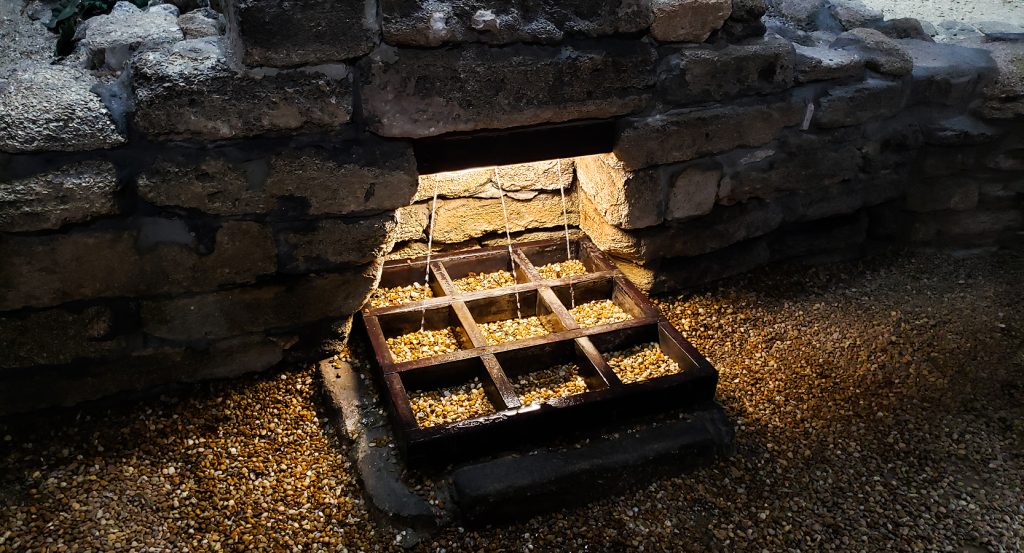 Close-up of the legendary Fountain of Youth spring site in Saint Augustine with illuminated trickling water.