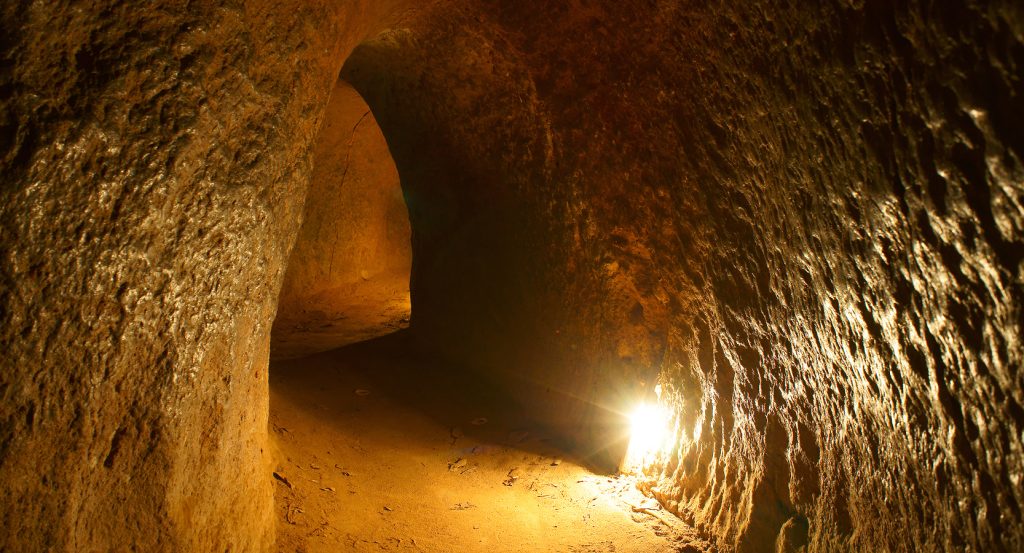 Historic underground war tunnel illuminated by soft light in Vietnam