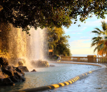 Golden sunset shining through a waterfall on Castle Hill in Nice, France.