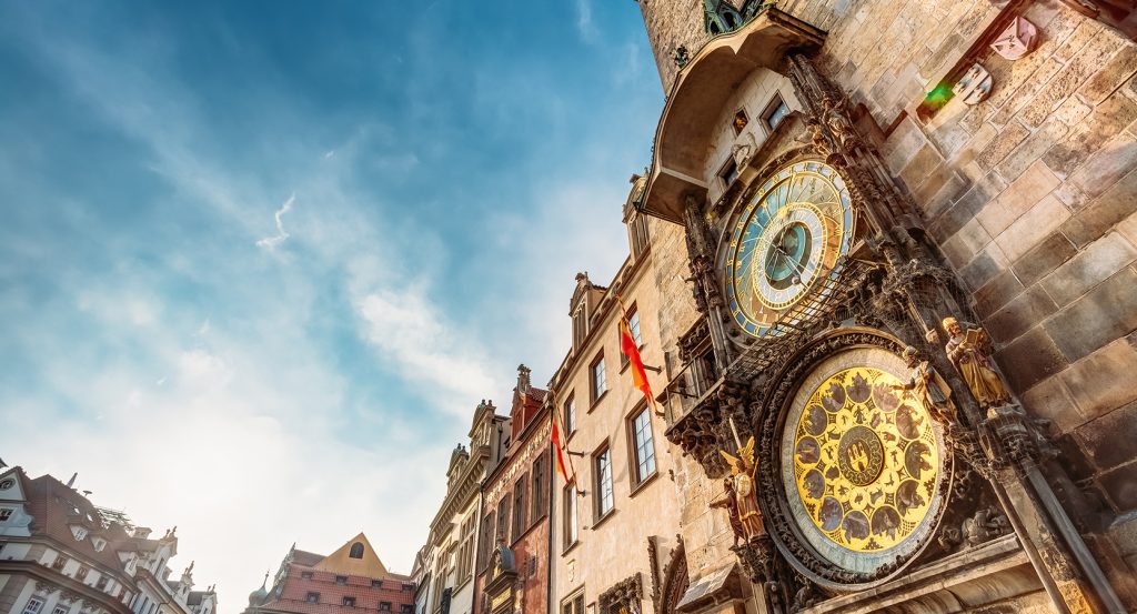 Historic medieval clock tower in Prague with zodiac and timekeeping details.