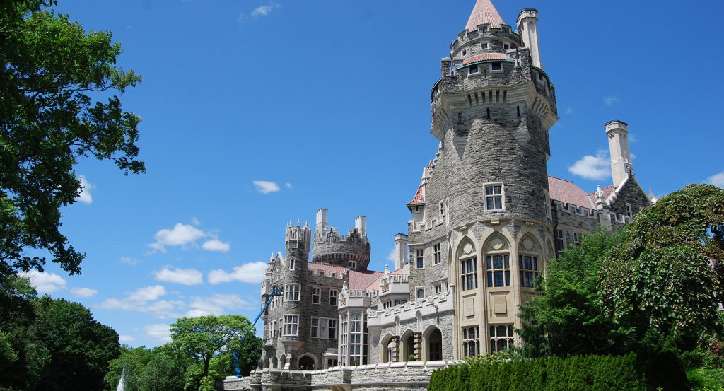 Historic castle surrounded by lush gardens in downtown Toronto.