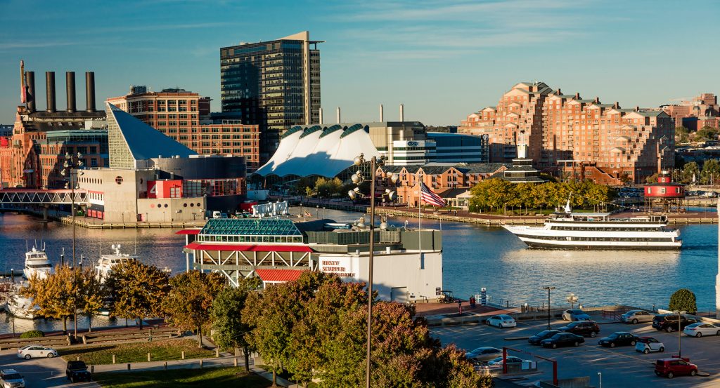 Panoramic view of Baltimore’s vibrant harborfront blending museums, ships, and contemporary cityscape.