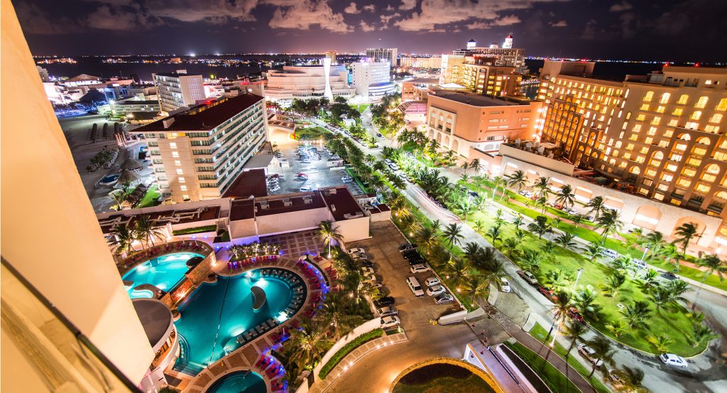 Cancun’s vibrant nightlife and beachfront resorts glowing under the evening sky