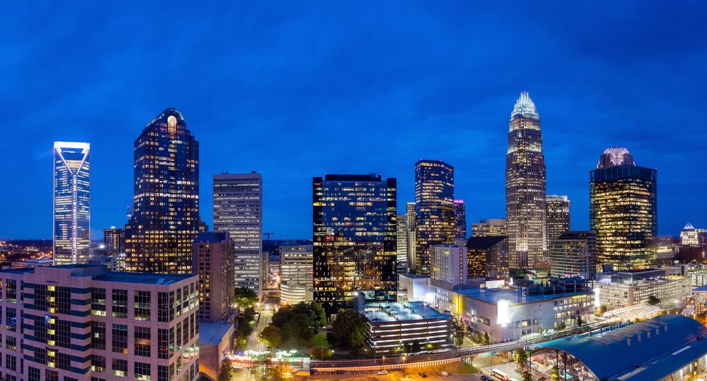 Uptown Charlotte’s modern skyscrapers lit up at twilight