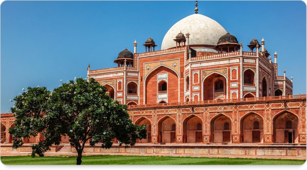 Humayun’s Tomb glowing at golden hour, framed by symmetrical Mughal gardens.