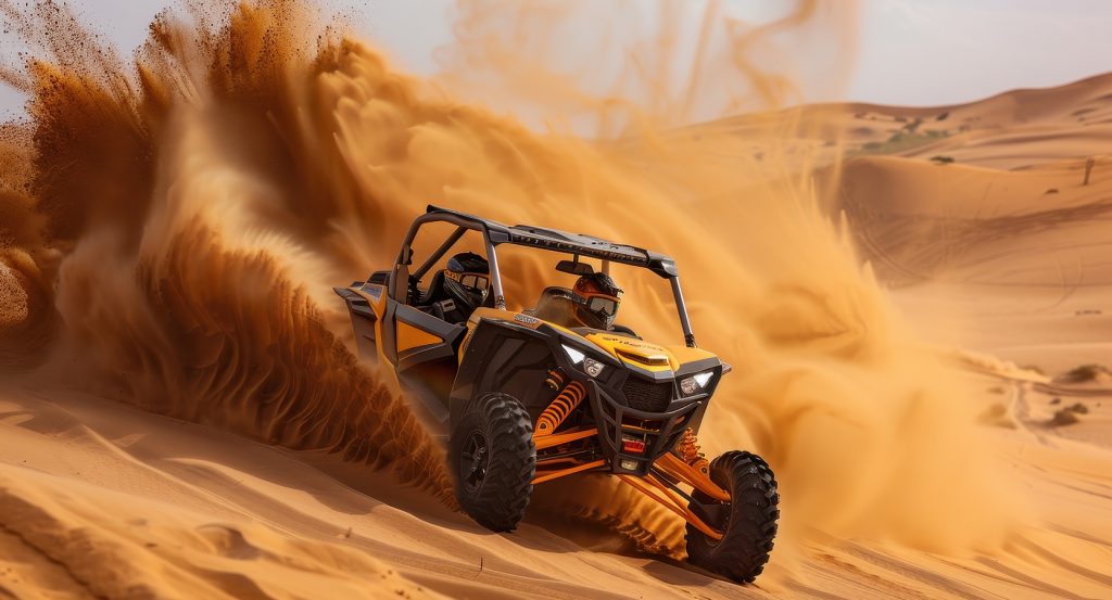 Off-road ATV powers through golden dunes under bright desert sun