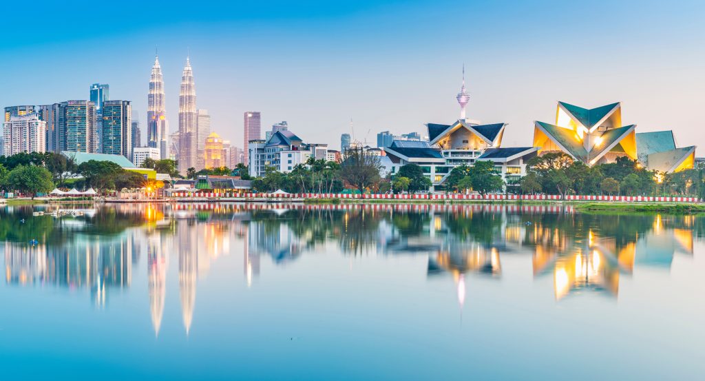 Modern architecture and natural beauty blend in Kuala Lumpur’s serene lakeside cityscape.