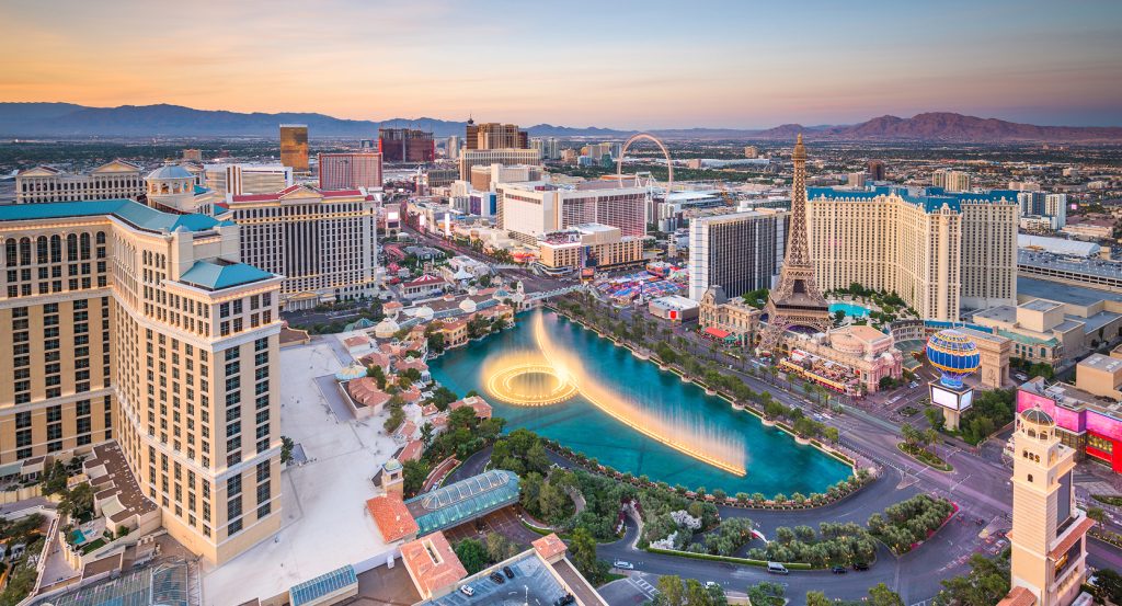 The Eiffel Tower replica and surrounding skyline glowing over the Strip’s iconic water show.