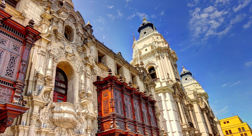 The grand facade of the Cathedral of Lima showcasing Spanish Baroque design and rich cultural detail.
