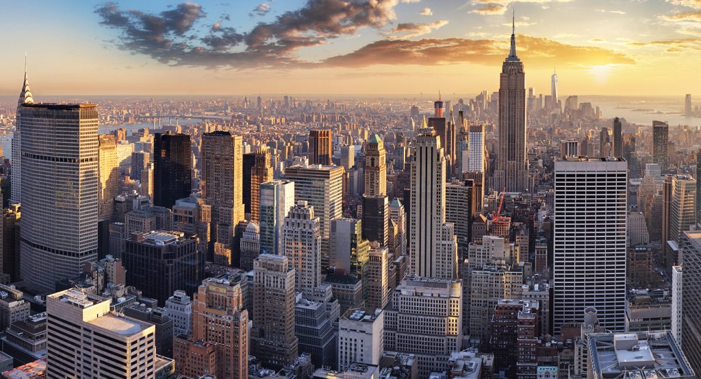 Iconic view of the Manhattan skyline from Brooklyn Bridge at sunset