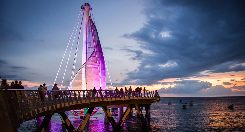 Sunset view of the iconic Los Muertos Pier extending over the ocean in Puerto Vallarta.