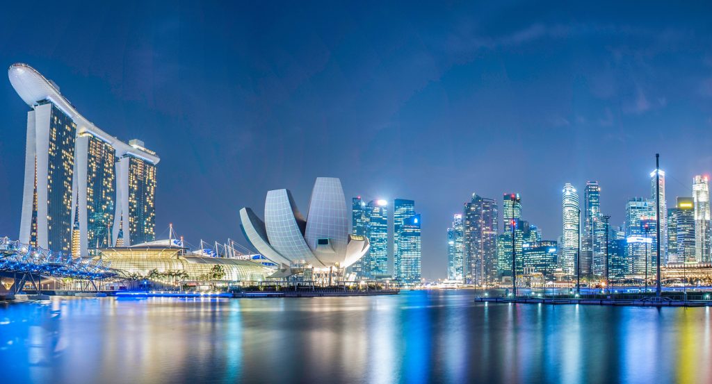 Futuristic cityscape of Singapore reflecting over Marina Bay