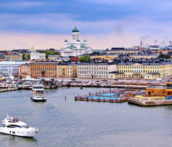 View of Helsinki harbor with boats and the white Helsinki Cathedral in the background