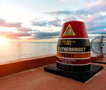Southernmost Point buoy at sunset along the Key West shoreline