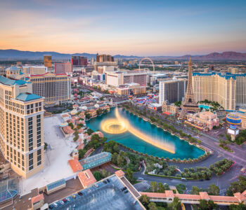 Daytime aerial view of the Las Vegas Strip with Bellagio Fountains and major resorts.