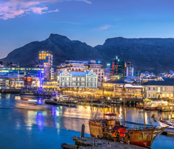 Cape Town waterfront skyline beneath Table Mountain at dusk