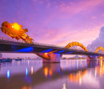 Dragon Bridge glowing over the Han River at dusk in Da Nang