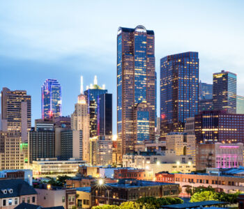 Downtown Dallas skyline illuminated at dusk