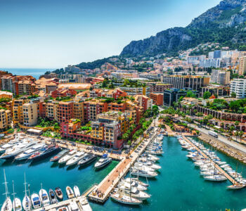 Elegant hotel overlooking the Monte Carlo marina with luxury yachts