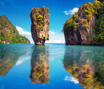 Limestone karst formations rising from turquoise water in Phang Nga Bay near Phuket, Thailand.
