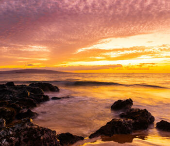Aerial view of Wailea’s crescent-shaped beaches with turquoise waters and luxury resorts nestled in tropical greenery.
