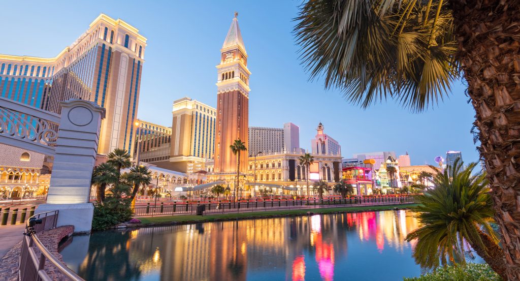 The Venetian Resort and shimmering lights of the Las Vegas Strip reflected in a peaceful canal at dusk