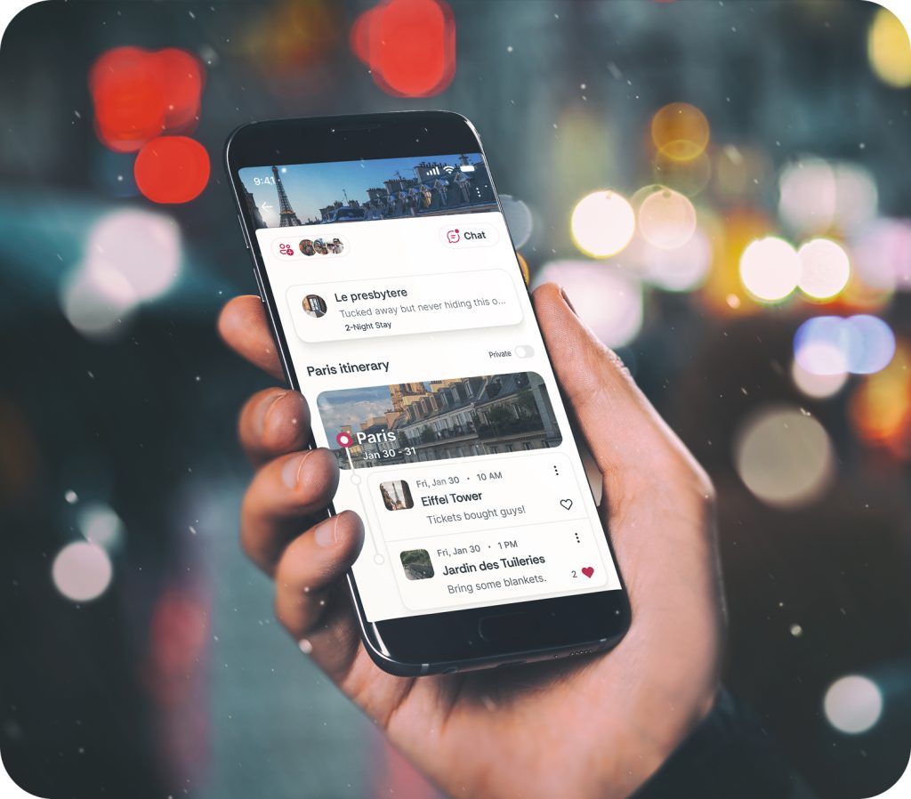 Hand holding a smartphone showing a travel planning app interface with a Paris itinerary, including saved activities like the Eiffel Tower Tour and Jardin des Tuileries, against a city nightscape background with colorful bokeh lights.-