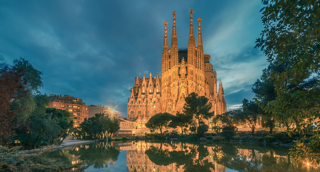 Reflection of La Sagrada Família Basilica across Plaça de Gaudí pond