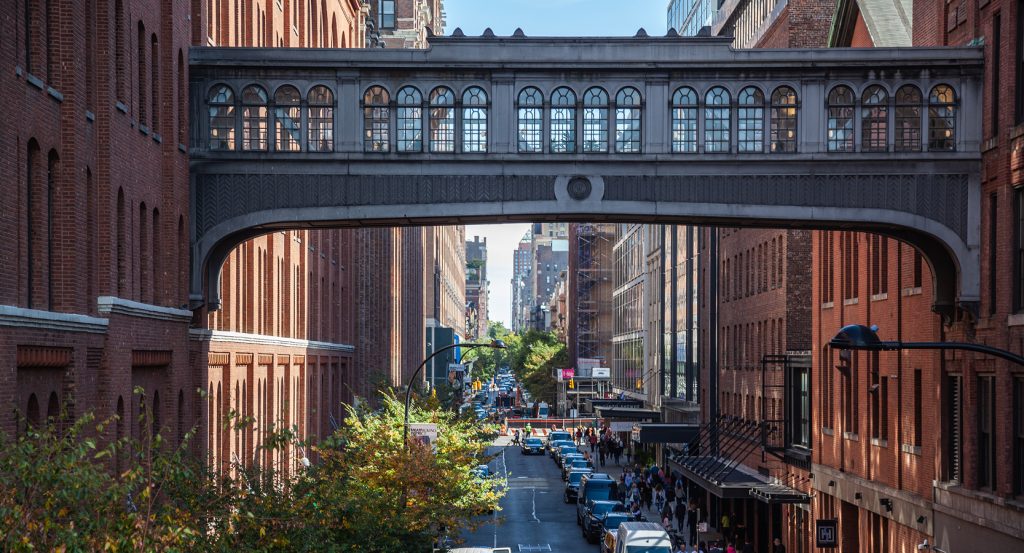 Inside Chelsea Market with bustling crowds and food stalls
