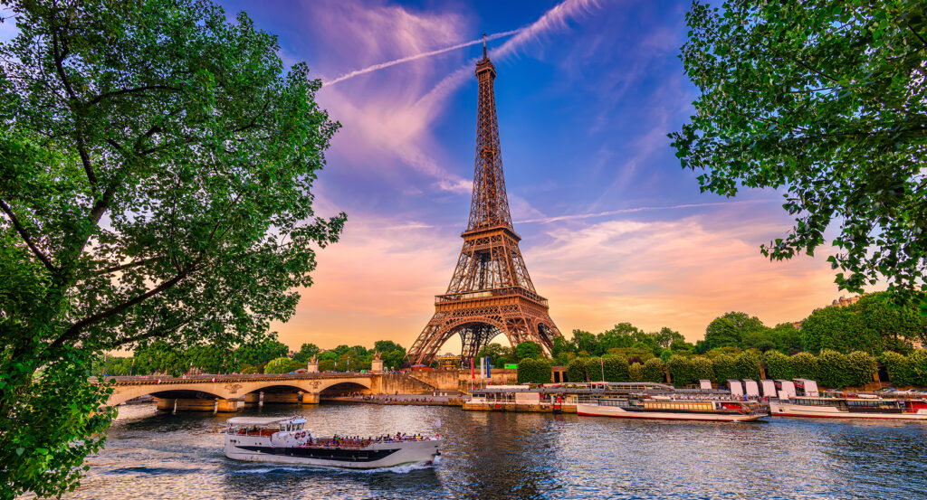 Eiffel Tower illuminated at night against Paris skyline