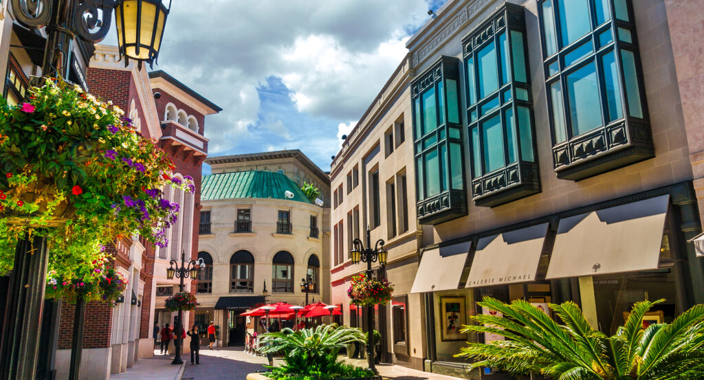 Vibrant shopping scene with flowers, palm trees, and designer stores on Rodeo Drive
