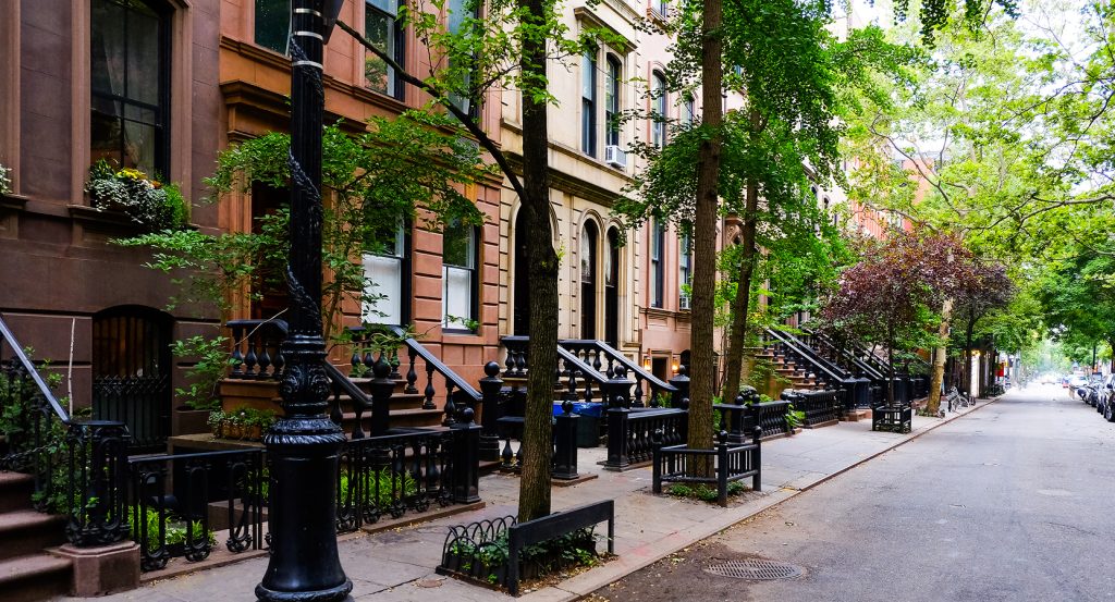 Washington Square Park arch with people gathering beneath
Caption: Greenwich Village blends history, counterculture, and cozy