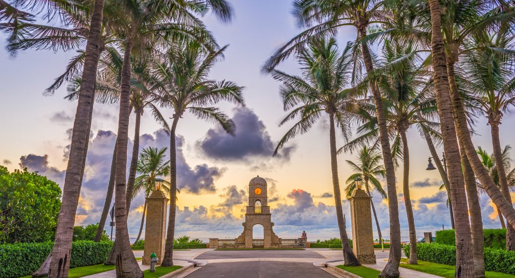 Worth Avenue Clock Tower framed by palm trees in Palm Beach, Florida