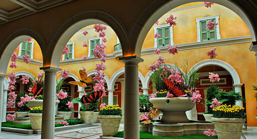 Vibrant spring floral display inside Bellagio Conservatory with butterflies and fountains