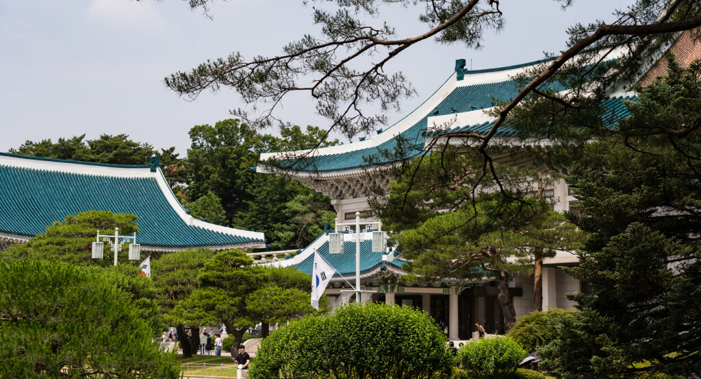 Blue House architecture framed by greenery in Seoul