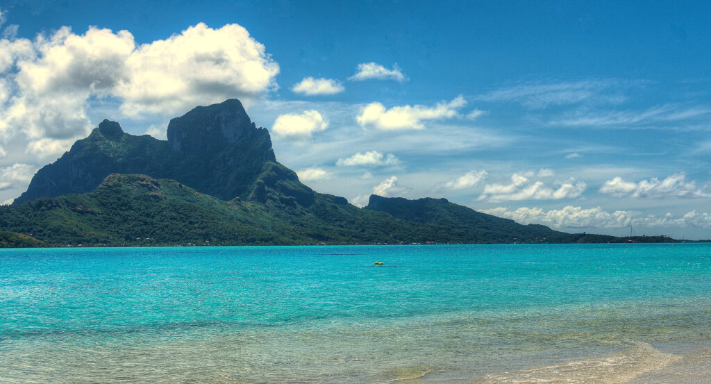 Motu Piti Aau shoreline with white sand and clear lagoon waters in Bora Bora