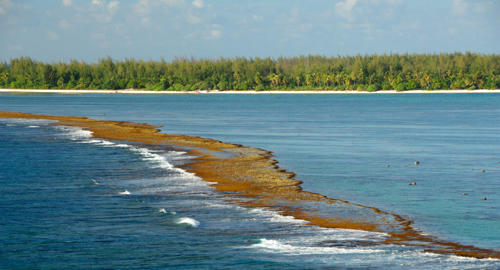 Aerial view of Teavanui Pass with coral reef and ocean waves