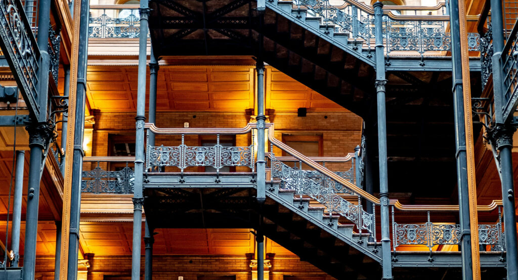 Interior view of Bradbury Building with glowing lights and detailed railings