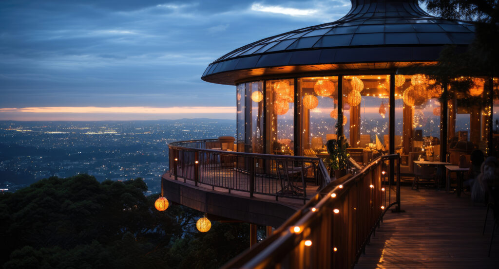 Scenic night view of Brisbane skyline from Mount Coot-tha Lookout with illuminated café terrace